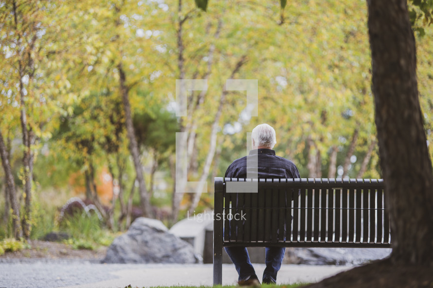 man sitting on a park bench 
