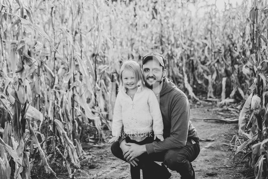 Man and daughter in corn stalks - black and white