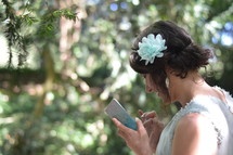 woman in a formal dress texting on a cellphone 