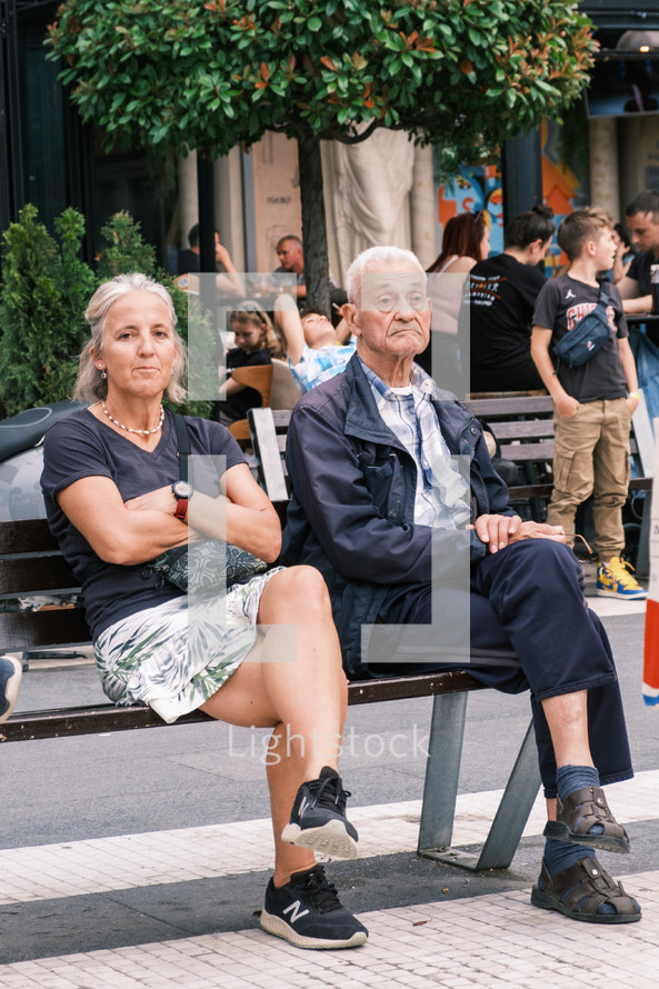 People sitting on a bench in Europe
