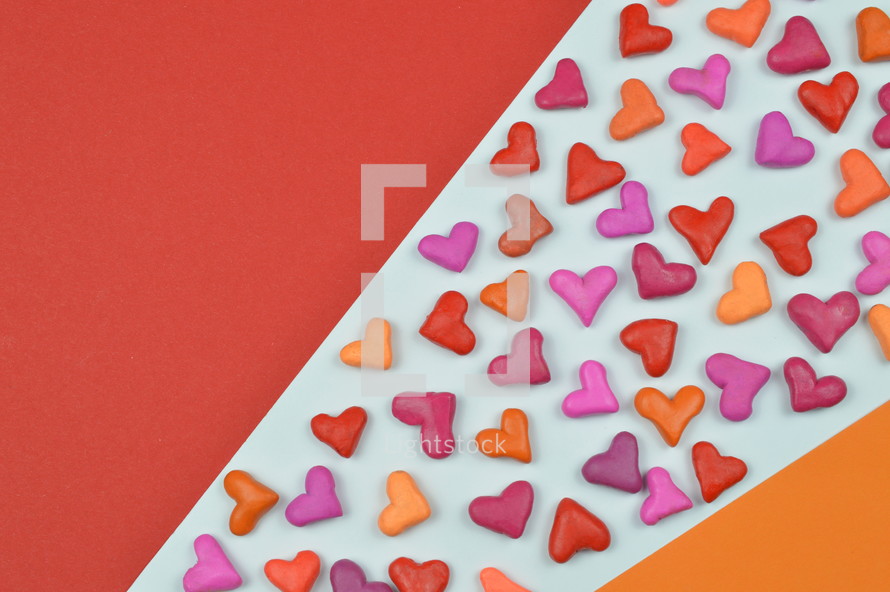 colorful heart shapes on red, yellow, and white background 