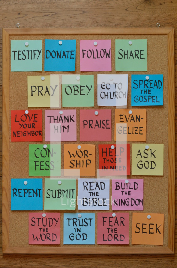 colorful notepads with new year's resolutions for christian life on a corkboard
