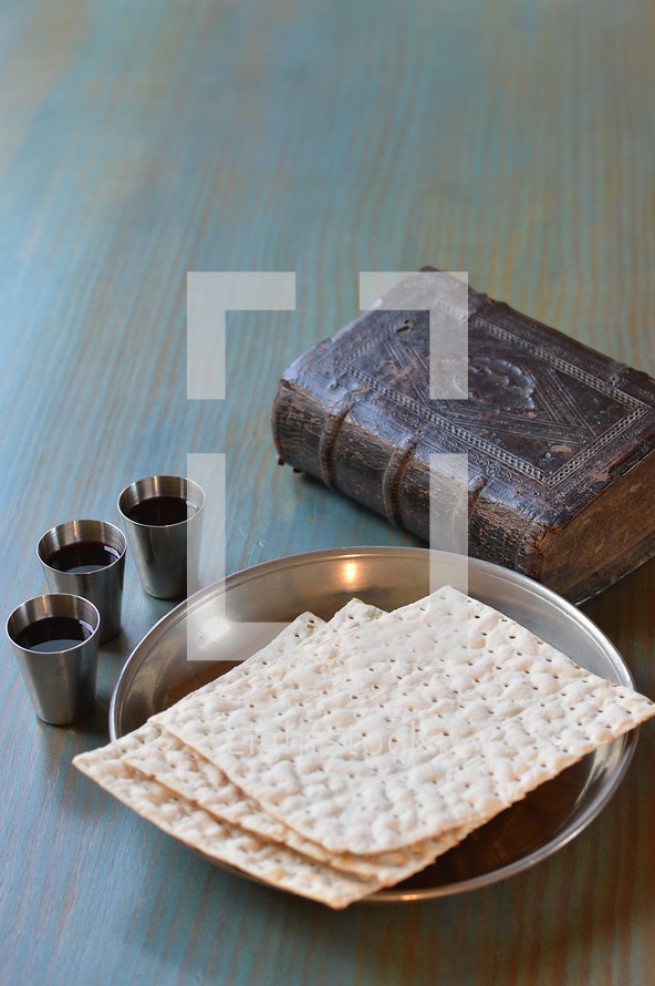 The Lord's Supper with bread, wine and an ancient bible. 