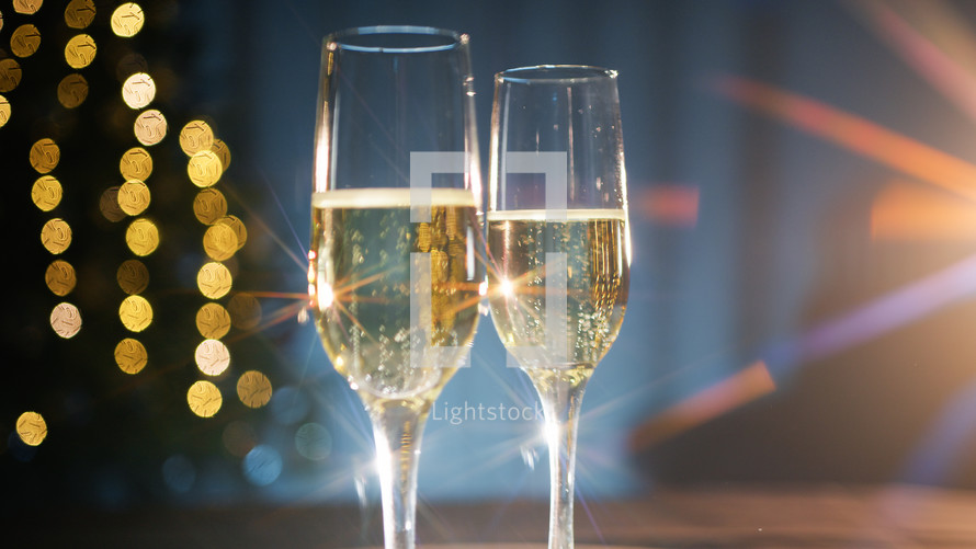 beam of light crashing into two champagne glasses