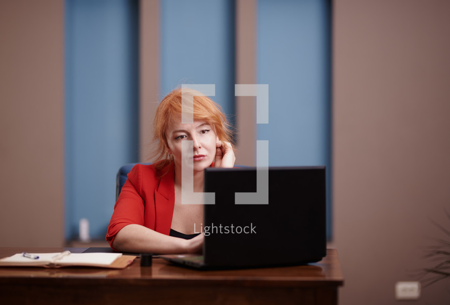 a woman at her desk and computer working 