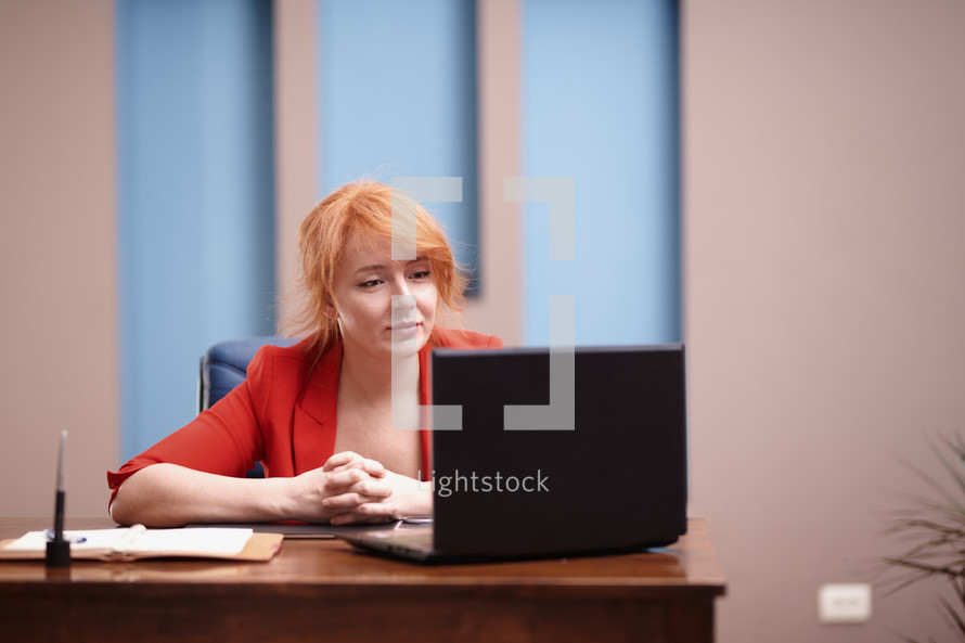 a woman at her desk and computer working 