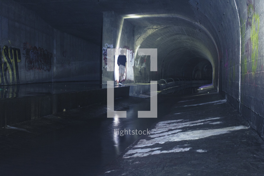 man standing in a tunnel 