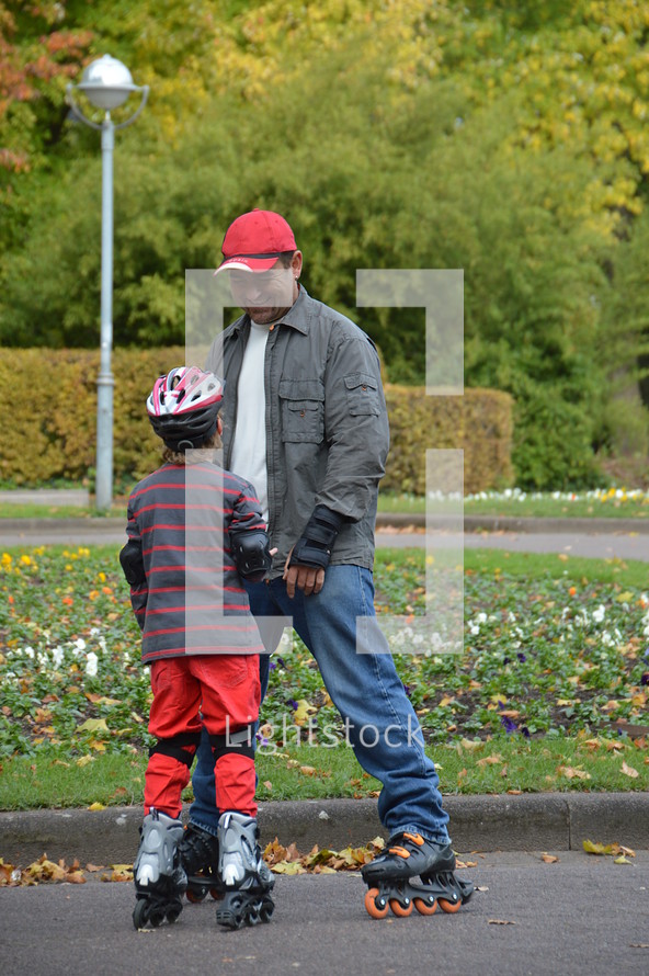 father and son roller blading together 
