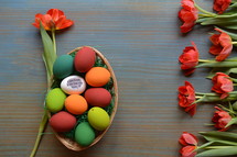 red tulips and a basket of Easter Eggs 