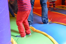 children bouncing in a bounce house. 