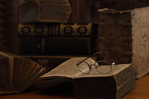 reading glasses on the pages of an old book 