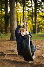 boy on a tire swing 