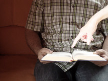 luminous hand point at a Bible passage
