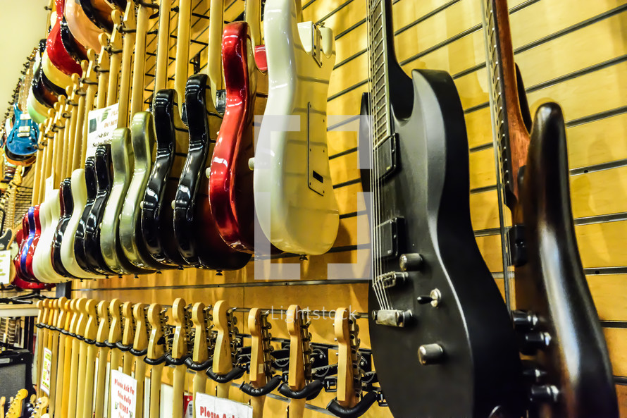 guitars hanging in a music store 