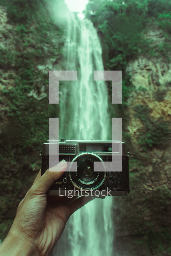a camera in front of a waterfall 
