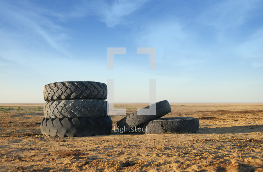 five tires in dirt 