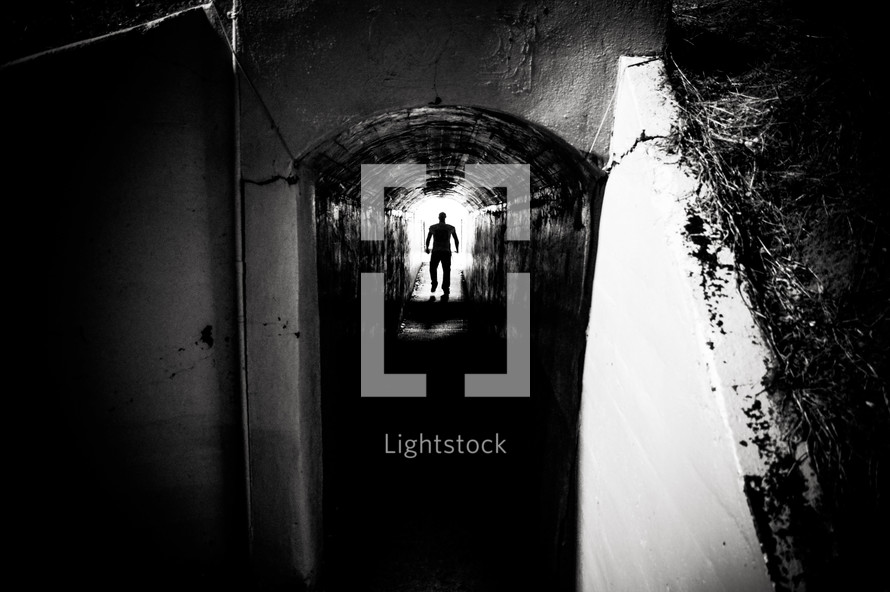 Silhouette of a man walking in a tunnel — Photo — Lightstock Silhouette Man Walking Tunnel