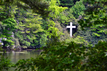 white cross by a lake 