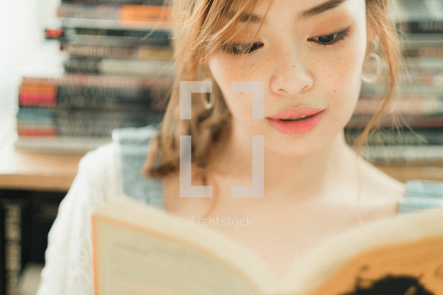 teen girl reading a book 