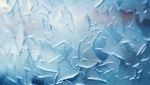 Frosty natural pattern on winter window. Abstract blue background.