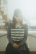 girl sitting in an office in a haze 