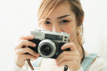 young woman holding a camera 