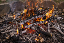 burning sticks in a campfire 