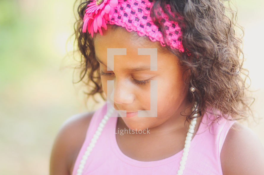 face of a young girl looking down 