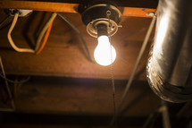 glowing lightbulb in an attic 