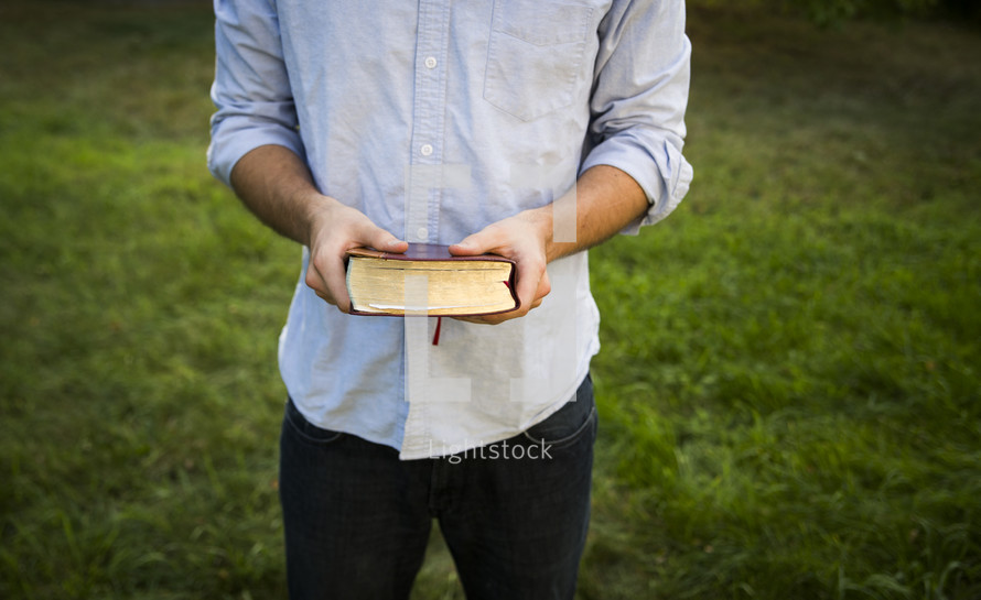 a man holding a Bible 