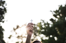 a man holding up a cross 