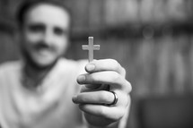 a man holding up a cross 