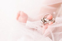 wedding rings on the toes of a newborn 