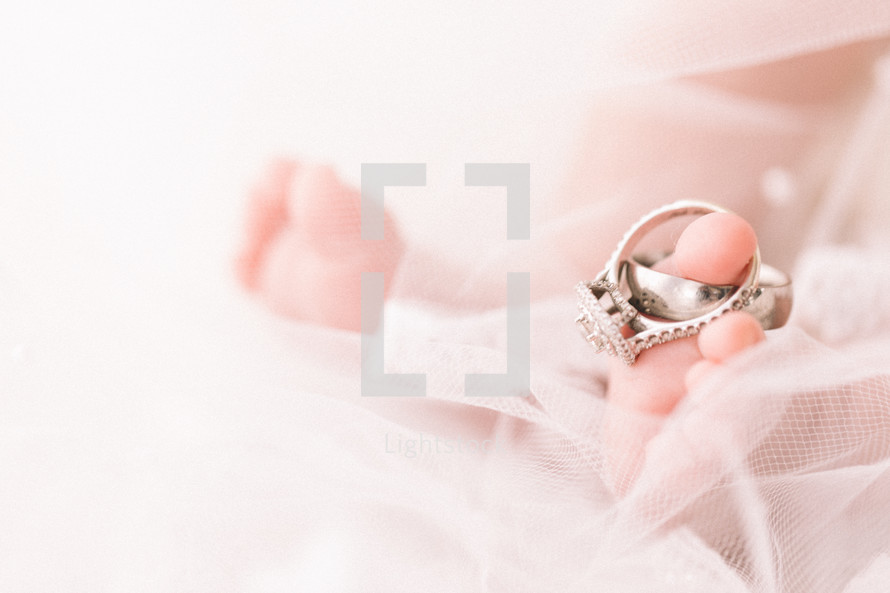 wedding rings on the toes of a newborn 
