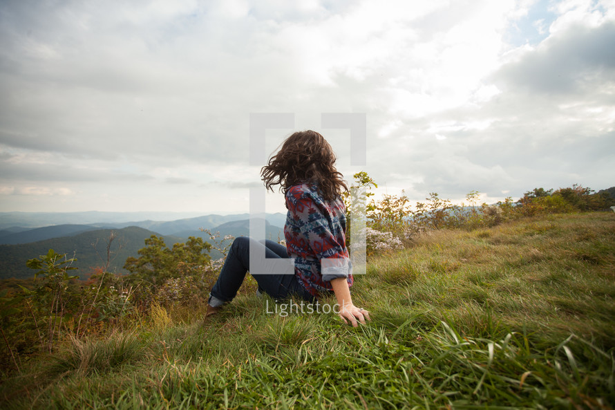 woman sitting in grass 