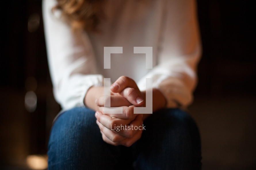 a woman with praying hands 