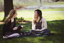 Bible study on a blanket in the grass 