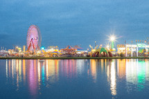 amusement park lights along a shore 