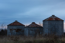 Metal, rusty silos on a farm