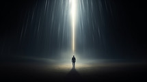 Man standing in a beam of light from the sky. 