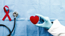world cancer awareness day heart in the hand of a doctor