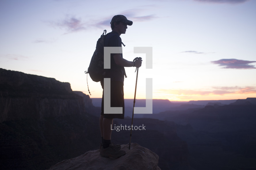 Silhouette of a mountain climber at sunrise.