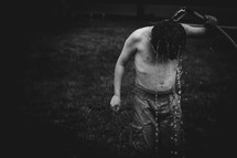 a child rising off with a water hose 