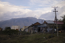 Rough looking building in Eastern Europe with mountains in background