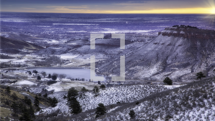 sunrise at Flatiron Reservoir located in southwest Loveland Colorado, Fresh snow on the Butte as the lake has frozen over