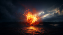 Ball of fire hovering over water with a dark sky. 