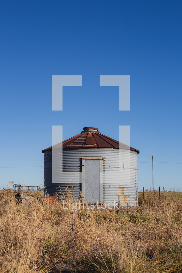 Rusty silo in a field