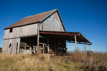 Wood building with rusted roof in rural area