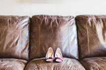heels on a leather couch 