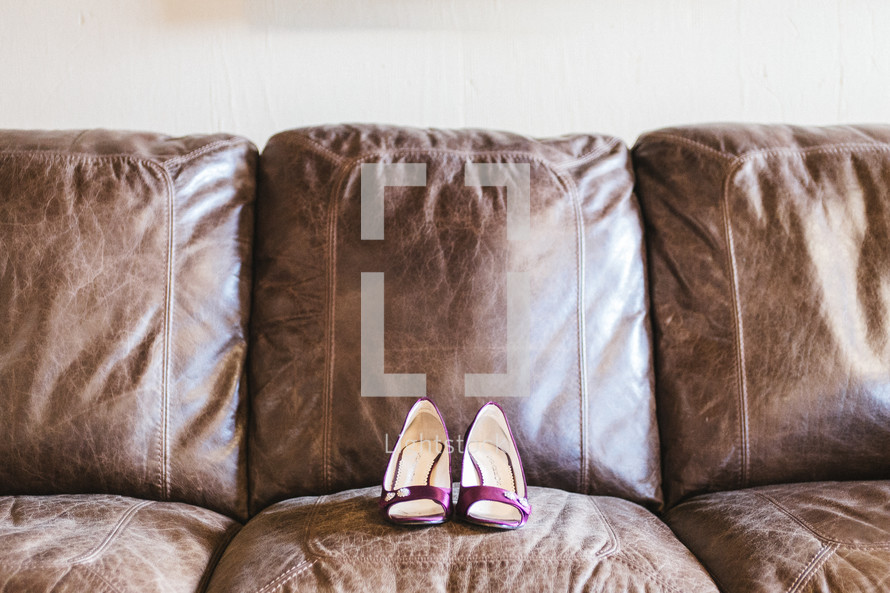 heels on a leather couch 